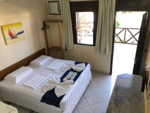 a bedroom with a bed with towels on it at Apart Hotel Litoral Sul in Natal +38 photos