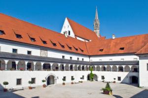 a large white building with a red roof at Hotel Kartause in Gaming