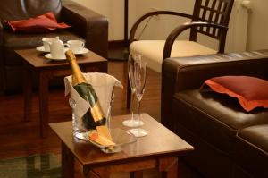 a living room with a bottle of champagne on a table at Vila Park B&B - Adults Only in Bohinj