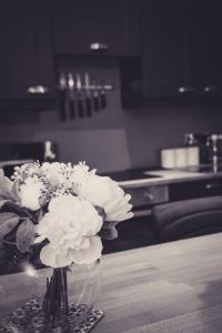 a vase of white flowers sitting on a table at The Bird House at Invergarry in Windermere