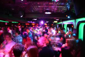 a crowd of people in a room with colored lights at Jackson Court Hotel in Dublin