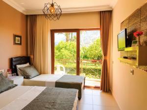 a hotel room with two beds and a window at Papirus Hotel in Adrasan +37 photos
