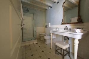 a bathroom with a sink and a shower and a toilet at Classique in Lazise