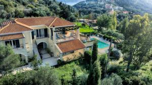 an aerial view of a house with a swimming pool at Spacious 4-Bedroom Villa with Private Pool and Stunning Sunset Views, 3 Minutes from the Beach in Afionas