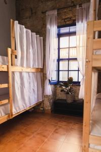 a room with two bunk beds and a window at Ashavana Hostel in El Médano