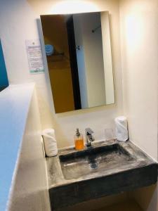a bathroom with a sink, toilet, and bathtub at Hotel Arcoiris Tulum in Tulum