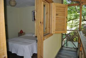 a room with a bed and a balcony at Hotel Loro Tuerto in Santa Cruz de Barahona