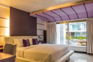 A bed or beds in a room at The L Resort Krabi - SHA Extra Plus