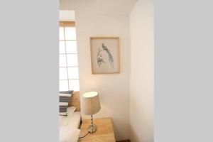 a white room with a lamp on a table at Uhome Suido Apartment SD in Tokyo