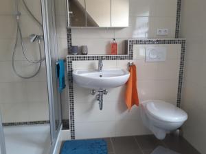 a bathroom with a sink and a toilet at Ferienwohnung Sabine in Koblenz +14 photos