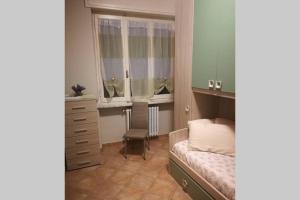 a bedroom with a bed and a dresser and two windows at "La ca` 'd Giaculin" -Casetta indipendente in Magliano Alpi +43 photos