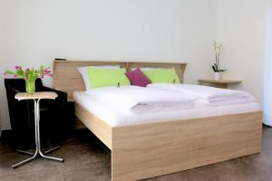 a bedroom with a bed with a wooden headboard at Alte Stadtmauer - Apartment in Sinsheim