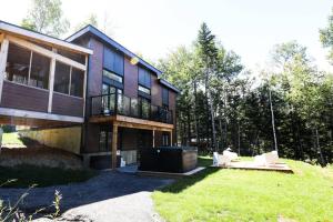 a large house with a lawn in front of it at Chalet le Raton in Chertsey