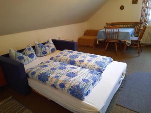 a bedroom with a bed with blue and white sheets at Haus Betz in Garmisch-Partenkirchen