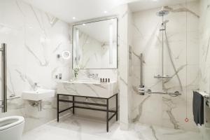 a white bathroom with a sink and a shower at The Grand, York in York +66 photos