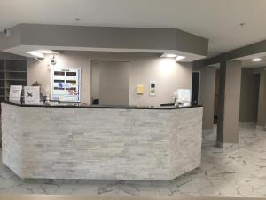 a lobby with a stone counter in a building at Microtel Inn by Wyndham Charlotte Airport in Charlotte