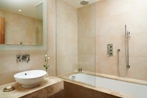 a bathroom with a tub and a sink and a shower at The Grand, York in York