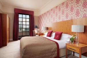 a hotel room with a large bed and a window at The Grand, York in York