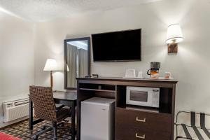 a hotel room with a desk and a microwave at Econo Lodge La Junta in La Junta