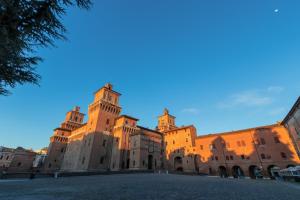 a large building with a clock tower on it at B&B Le Campane in Ferrara
