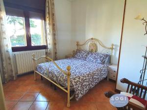 a bedroom with a bed and a window at Casa Sbrindoli in Lido di Jesolo