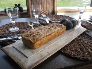 a table with a loaf of bread on a cutting board at Hrifunes Guesthouse in Hrífunes 