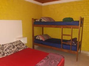 two bunk beds in a room with a bed at Las Hermanas in Las Grutas