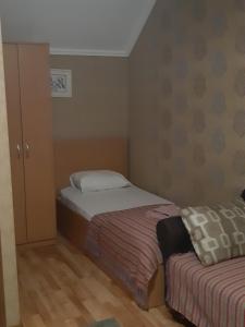 a small bedroom with two beds and a cabinet at Zlata Praha in Mukacheve