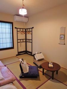 a living room with a couch and a table at Guesthouse Engawa in Kyoto