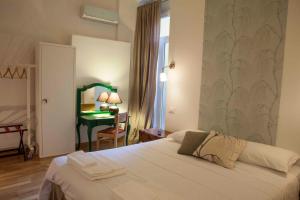 Katil atau katil-katil dalam bilik di Albergo delle Spezie