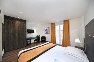a bedroom with a large bed and a desk in it at Hotel de la Jamagne & Spa in Gérardmer