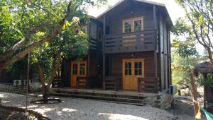 a wooden house in the middle of trees at Kashid Heritage Beach Resort in Kashid +17 photos