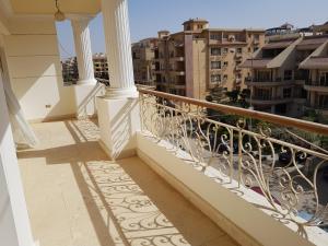 a balcony with a view of the city at Elite Homes 3BR Sunny Apartment Families Only in 6th Of October