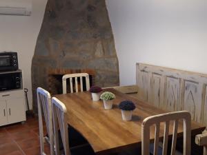 a wooden table with chairs and plants on it at Casa rural La tía María in Pereruela