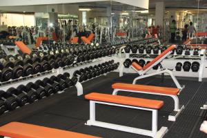a gym filled with lots of rows of exercise equipment at Hotel Real Zapopan in Guadalajara