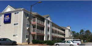 un grande condominio con macchine parcheggiate di fronte di InTown Suites Extended Stay Albany GA ad Albany