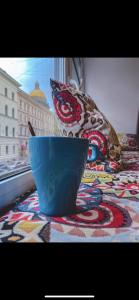 a blue bowl sitting on a table next to a window at Amore in Saint Petersburg