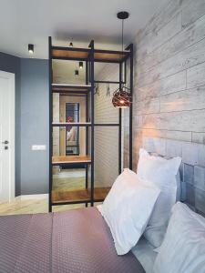 ein Schlafzimmer mit einem Bett und einer Holzwand in der Unterkunft Ayezova 7, LOFT apartment in Öskemen