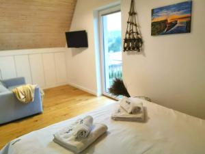 una camera con un letto con due asciugamani di Relax Houses - Domy Mazur a Małkinie