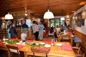 a group of people standing in a restaurant at Posada Queulat in Puerto Puyuhuapi