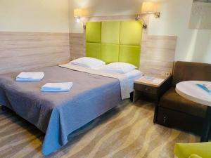 a bedroom with a bed with two towels on it at Hotel Willa Złota in Karwia
