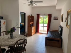 a living room with a table and a bedroom at Apart Orange in Pilar