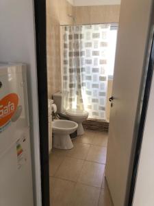 a bathroom with two toilets and a window at Apart Orange in Pilar +6 photos
