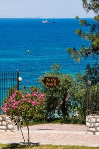 a sign that reads to like beach next to the ocean at Villa Victoria by La Scala Beach in Limenas