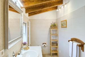 a bathroom with a sink and a mirror at Casas Rurales El Llugarón in Miravalles +58 photos