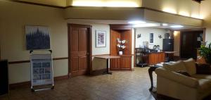 a living room with a couch and a table at Americas Best Value Inn Chippewa Falls in Chippewa Falls +8 photos