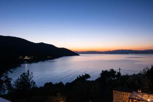 a view of a body of water at sunset at Villa Victoria by La Scala Beach in Limenas