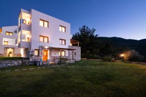 a large house with a yard in front of it at Villa Victoria by La Scala Beach in Limenas