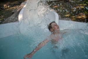 a young man is in a pool of water at Cabañas Trancas y Barrancas in Salsipuedes