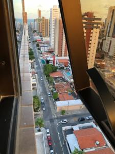 a view of a city street from a window at Magnífico Flat no melhor de Manaíra - Apart Hotel in João Pessoa